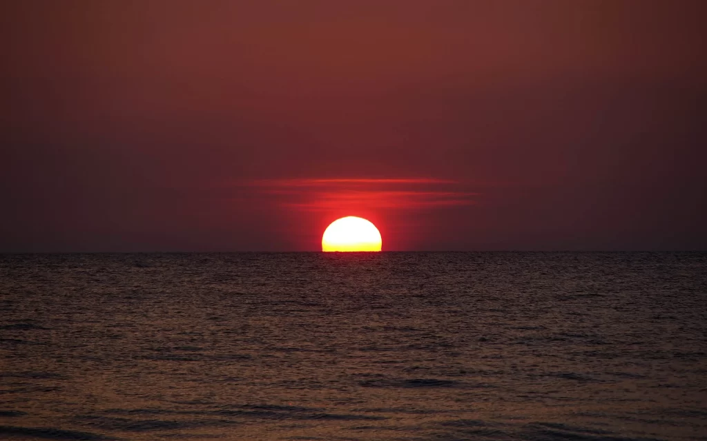 Sunset ocean horizon sky clouds reflection