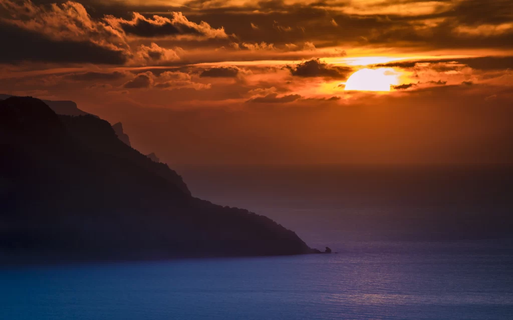 Sunset ocean mountain clouds horizon tranquil