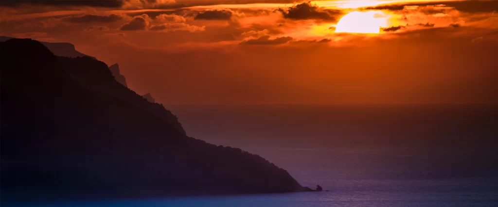 Sunset, ocean, mountains, clouds, sky, warm colors