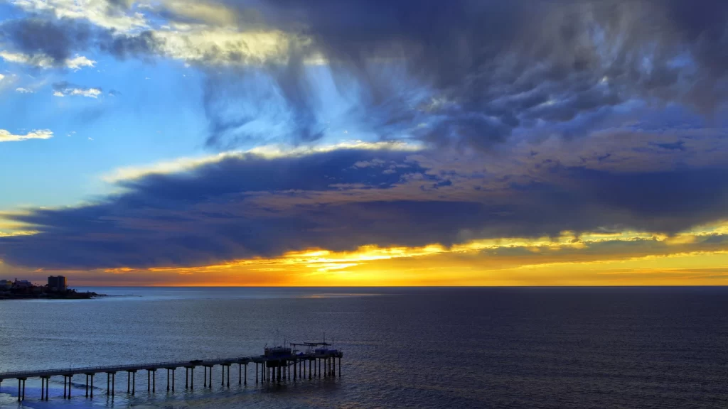 Sunset ocean pier clouds sky horizon