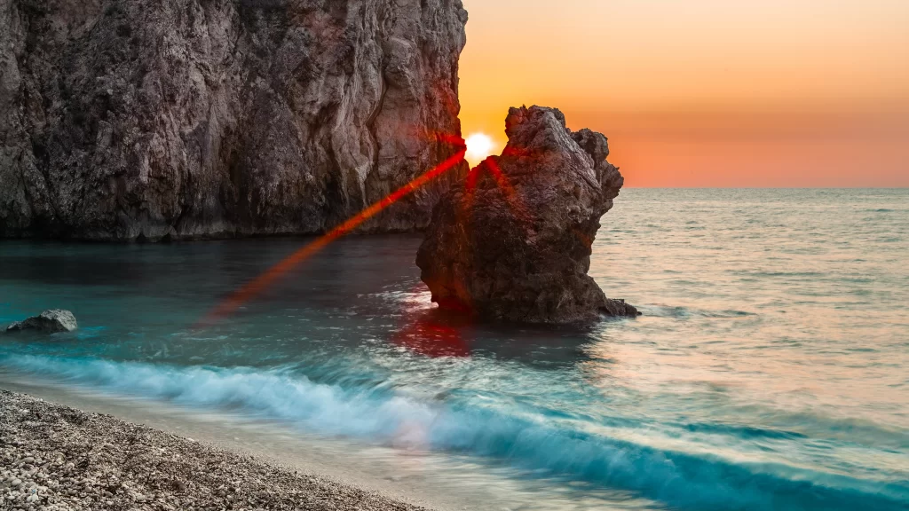 Sunset ocean rock waves sky horizon