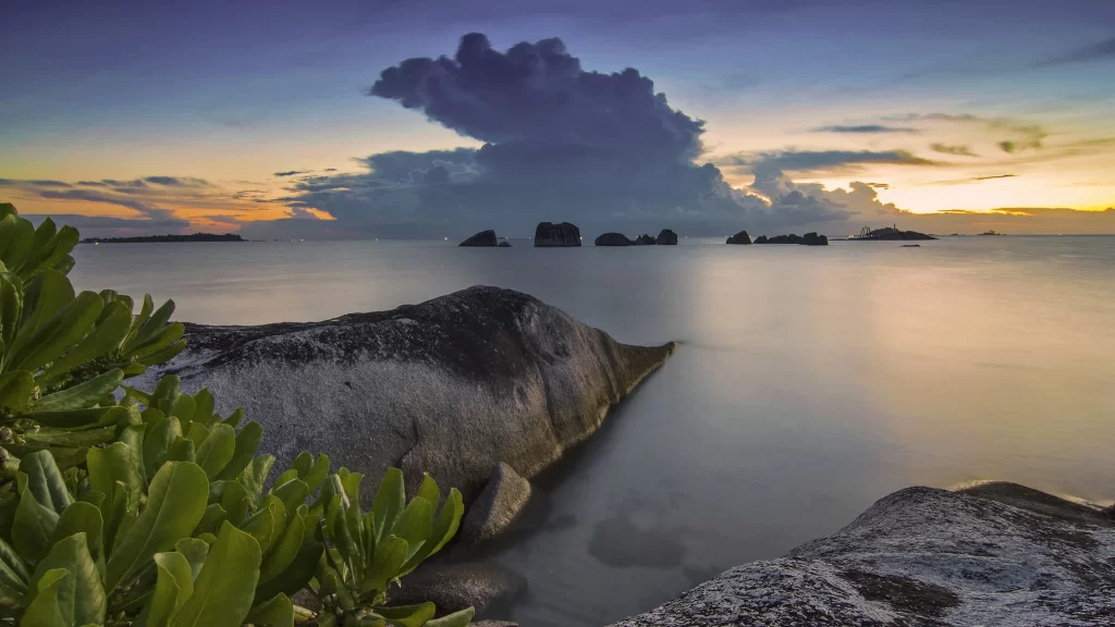 Sunset ocean rocks clouds calm nature