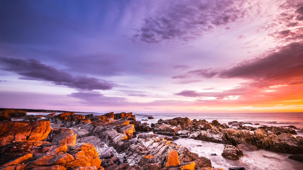 Sunset ocean rocks clouds horizon colors