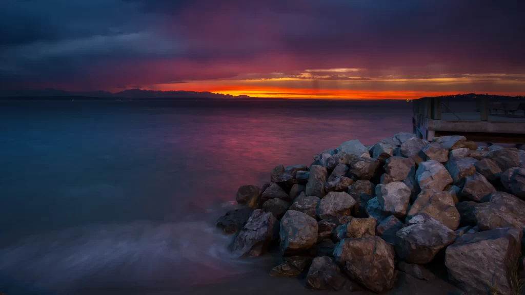Sunset ocean rocks clouds horizon colors