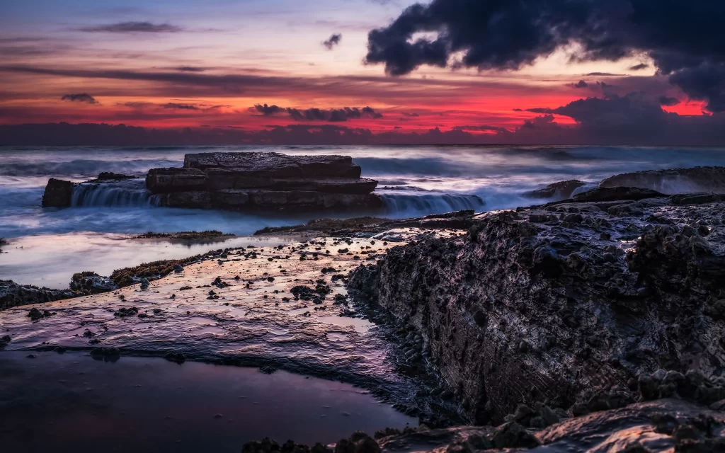 Sunset ocean rocks clouds horizon waves
