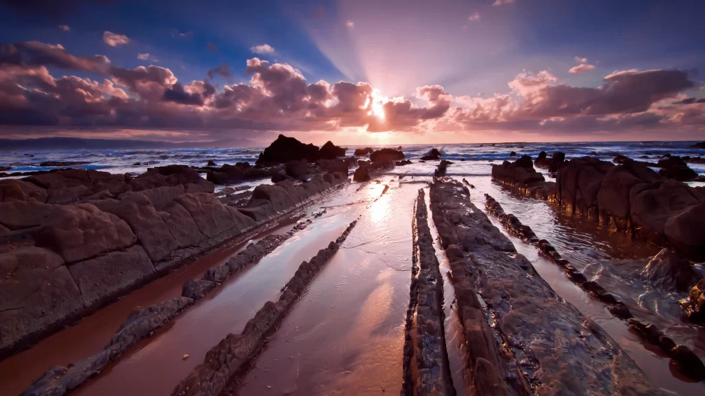 Sunset ocean rocks clouds reflection horizon
