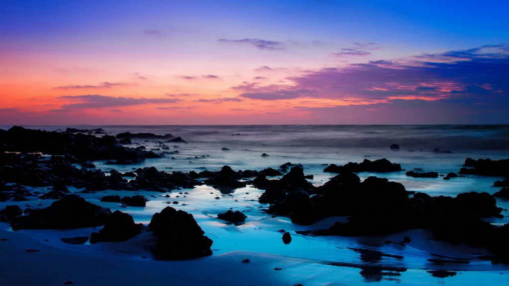 Sunset ocean rocks sky clouds reflection
