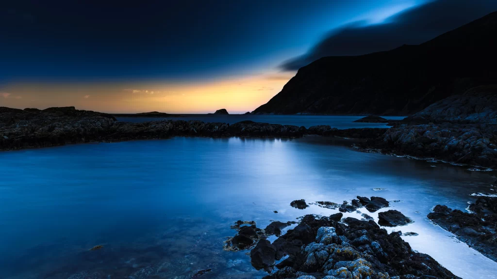 Sunset ocean rocks sky clouds reflection