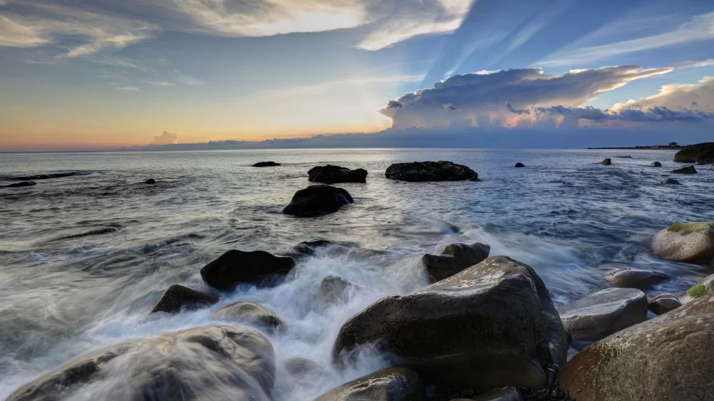 Sunset ocean rocks waves clouds sky