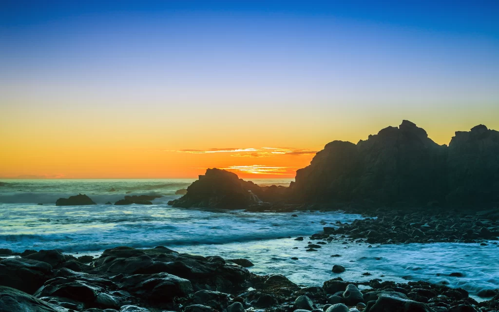 Sunset ocean rocks waves sky horizon
