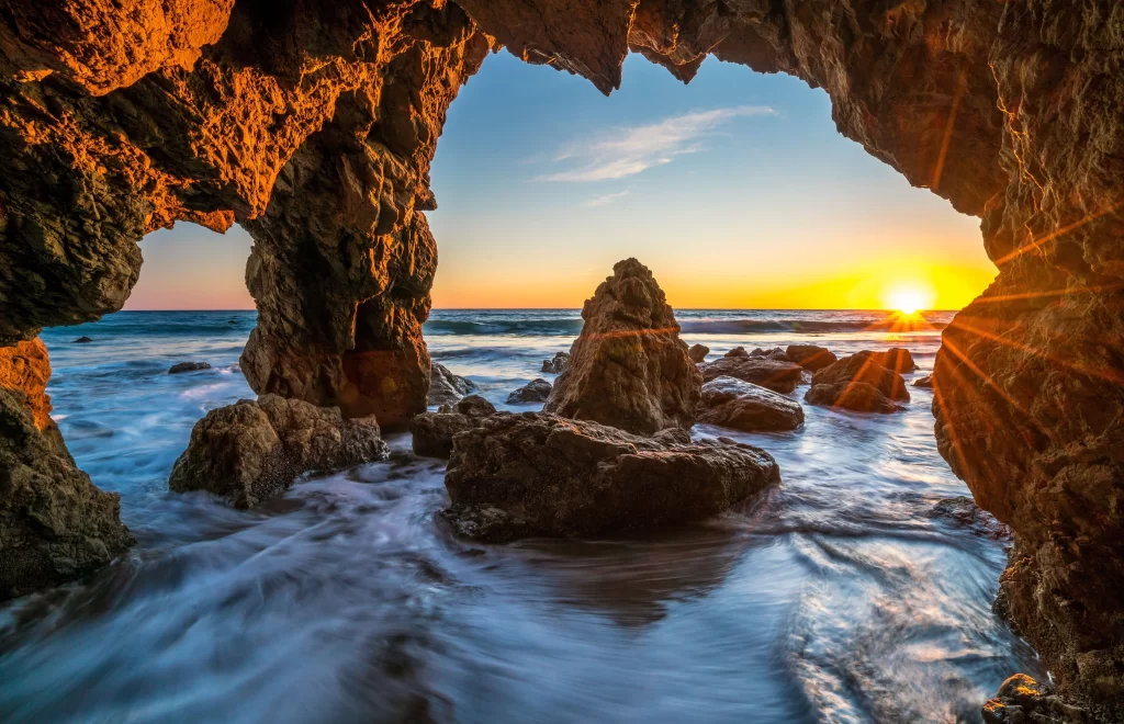Sunset ocean rocks waves sky horizon