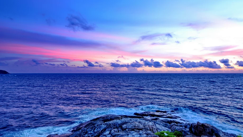 Sunset ocean sky clouds rocks waves horizon colors