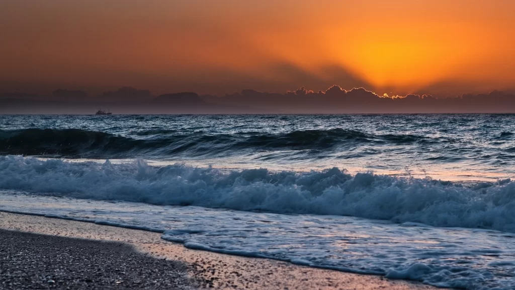 Sunset ocean waves beach sky clouds