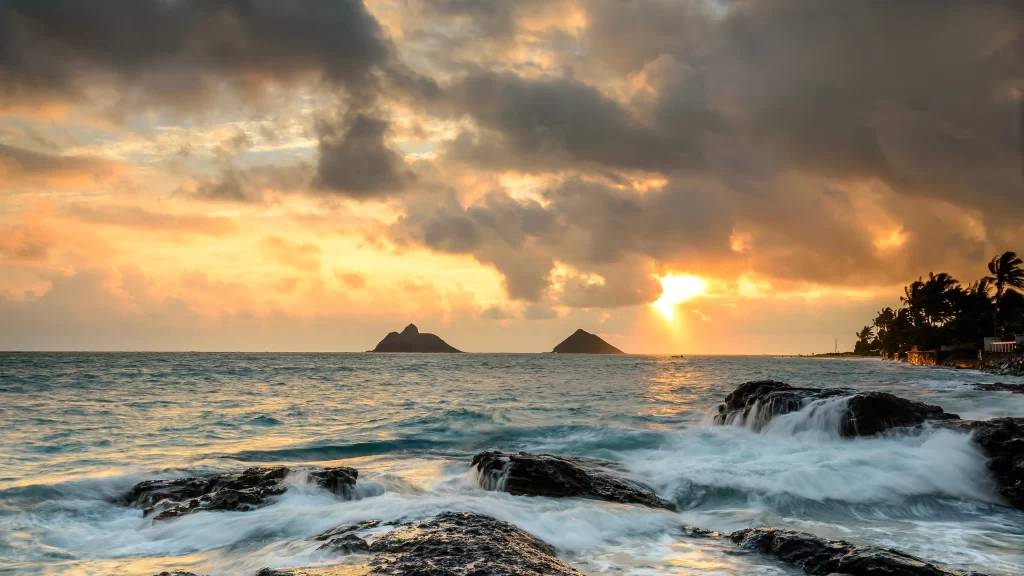 Sunset ocean waves rocks clouds sky