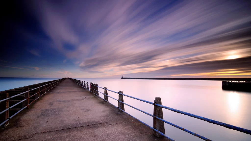 Sunset pier ocean clouds reflection tranquility