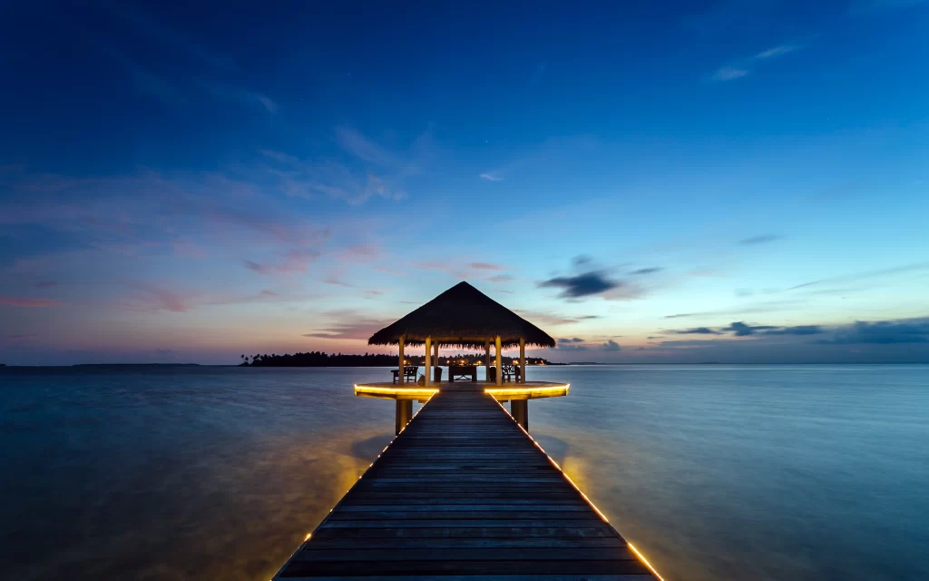 Sunset pier ocean gazebo lights tranquility