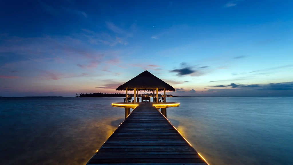 Sunset pier ocean gazebo lights tranquility