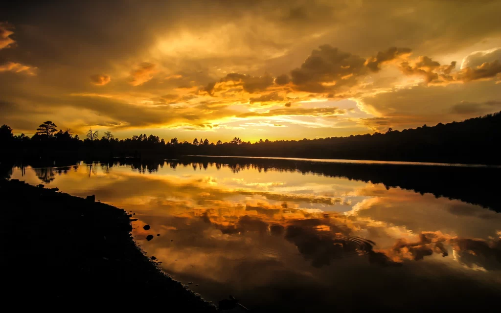 Sunset reflection lake clouds trees sky