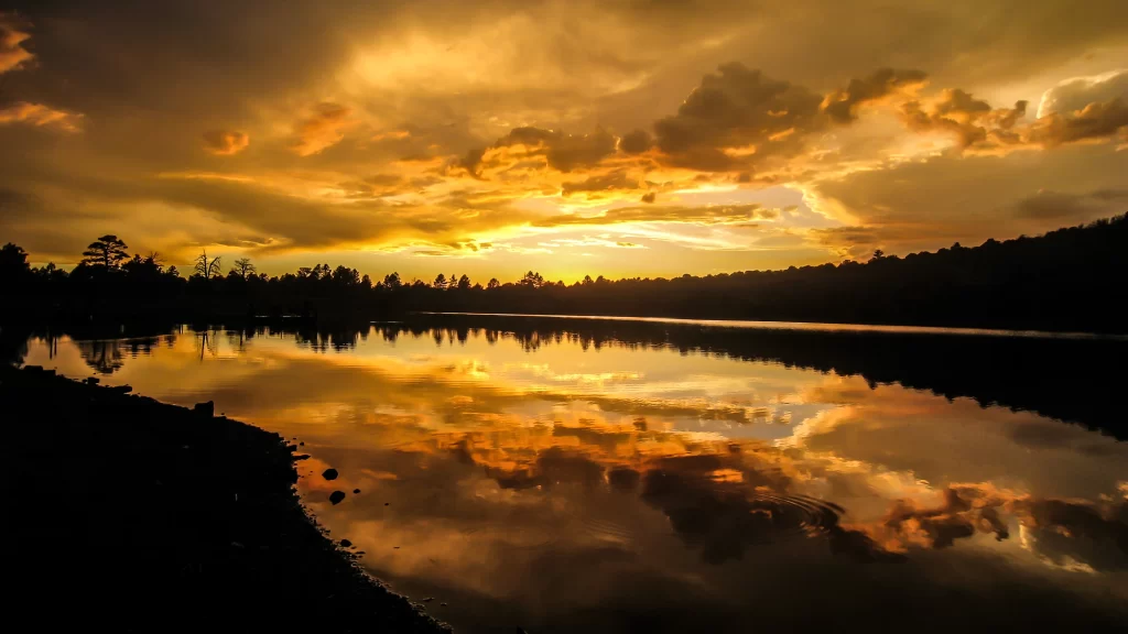 Sunset reflection lake clouds trees sky