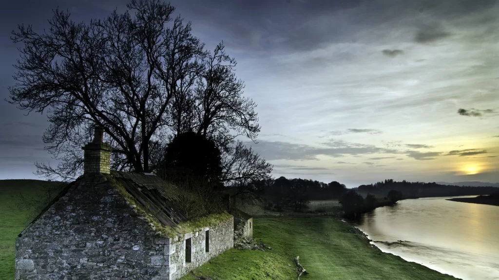 Sunset river stone house tree sky clouds