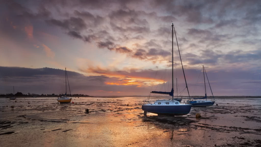 Sunset sailboats calm water clouds reflection tranquil horizon