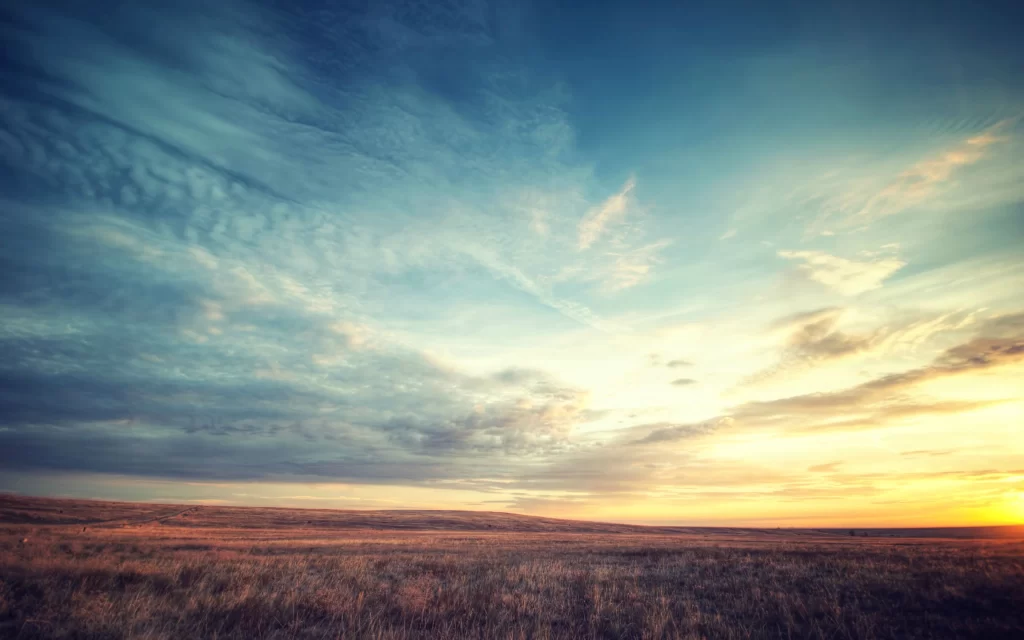 Sunset sky clouds field landscape serene