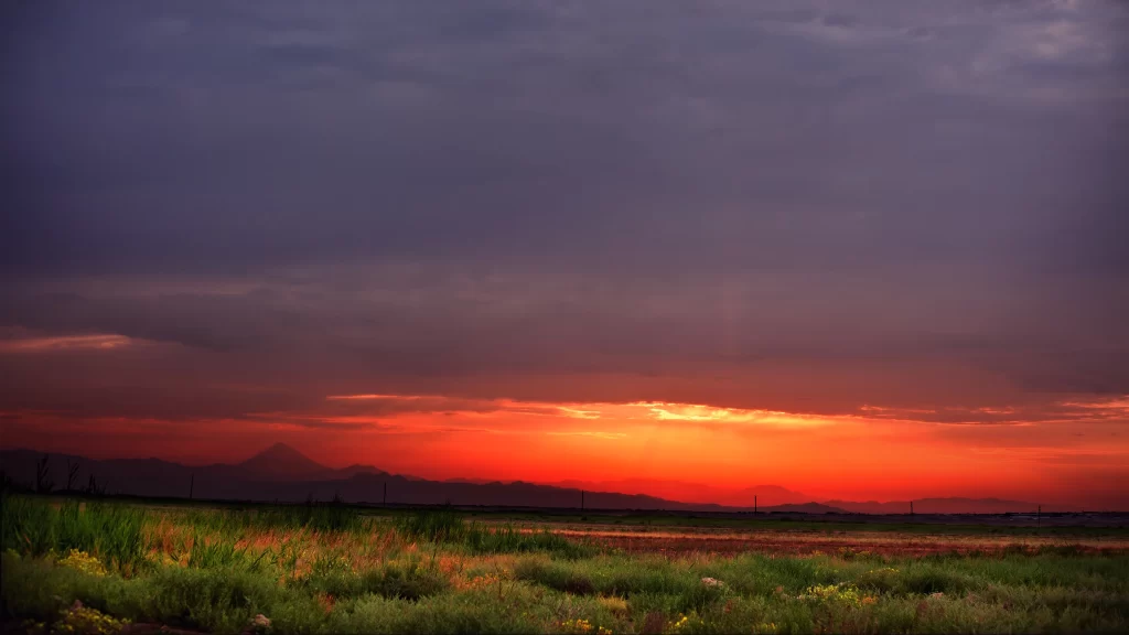 Sunset sky clouds landscape grass horizon colors tranquility