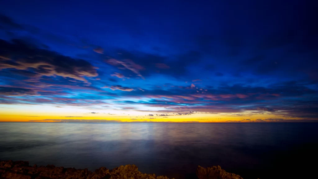 Sunset sky clouds ocean horizon colors tranquil serene
