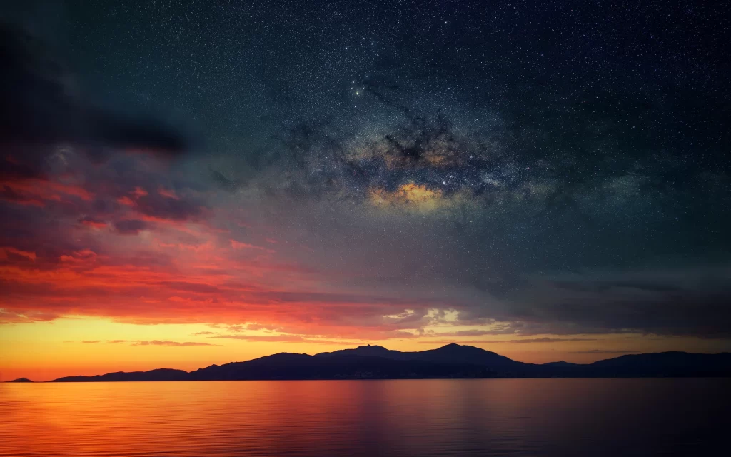 Sunset stars sky clouds mountains water reflection horizon