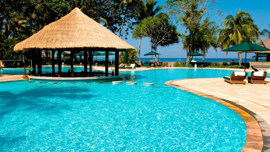 Swimming pool beach lounge chairs tropical relaxation ocean view