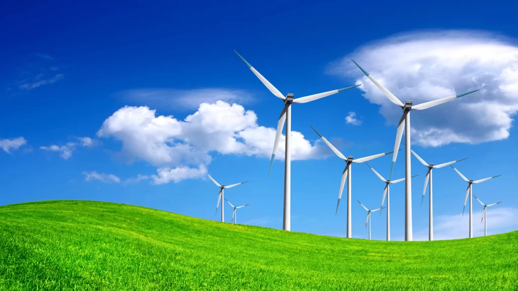 Wind turbines, green grass, blue sky, white clouds, renewable energy