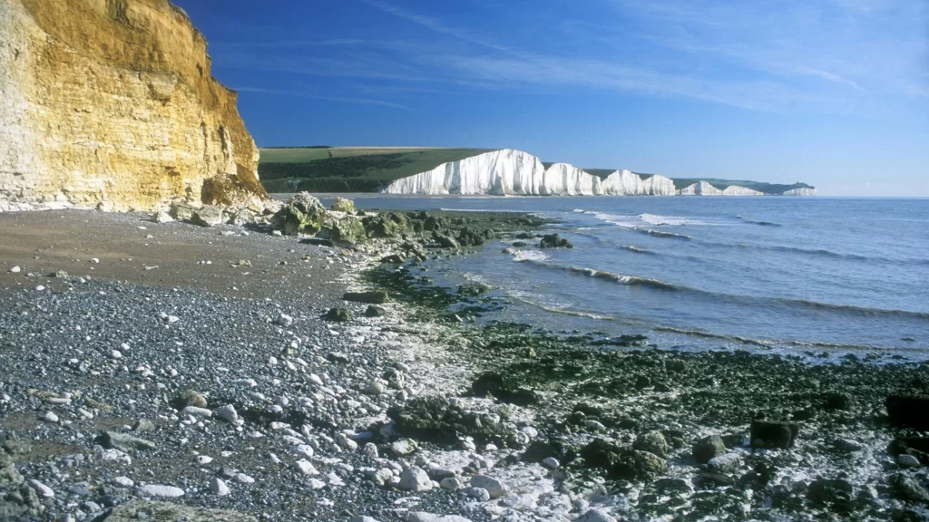 beach cliffs ocean rocks sky waves