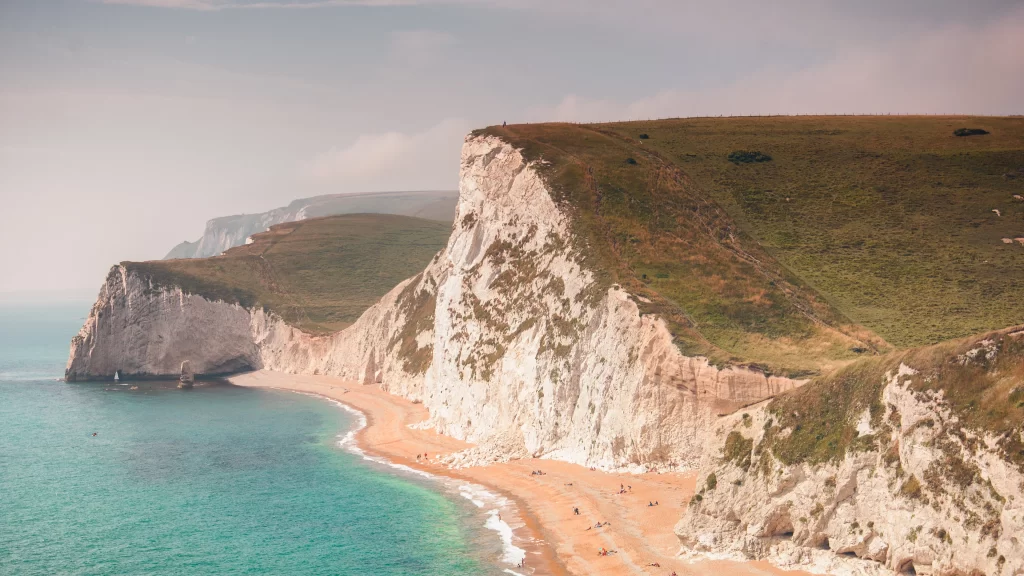 beach cliffs ocean sky grass landscape