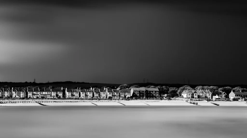 beach houses sky clouds water horizon