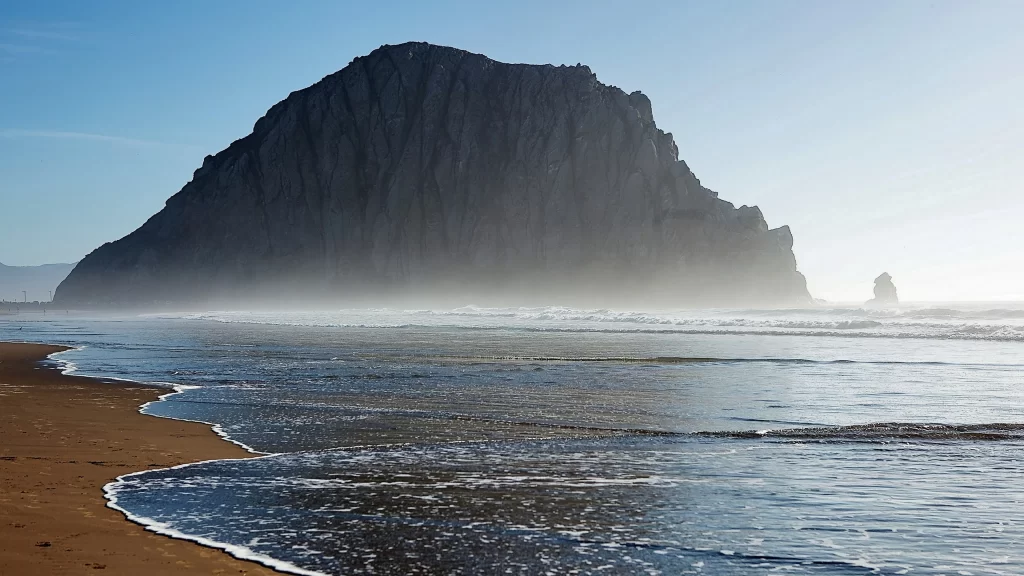 beach mountain ocean waves sand