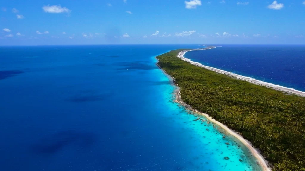 beach ocean island blue water sky clouds nature