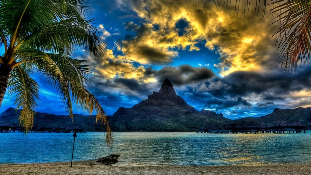 beach ocean mountain sunset clouds palm trees