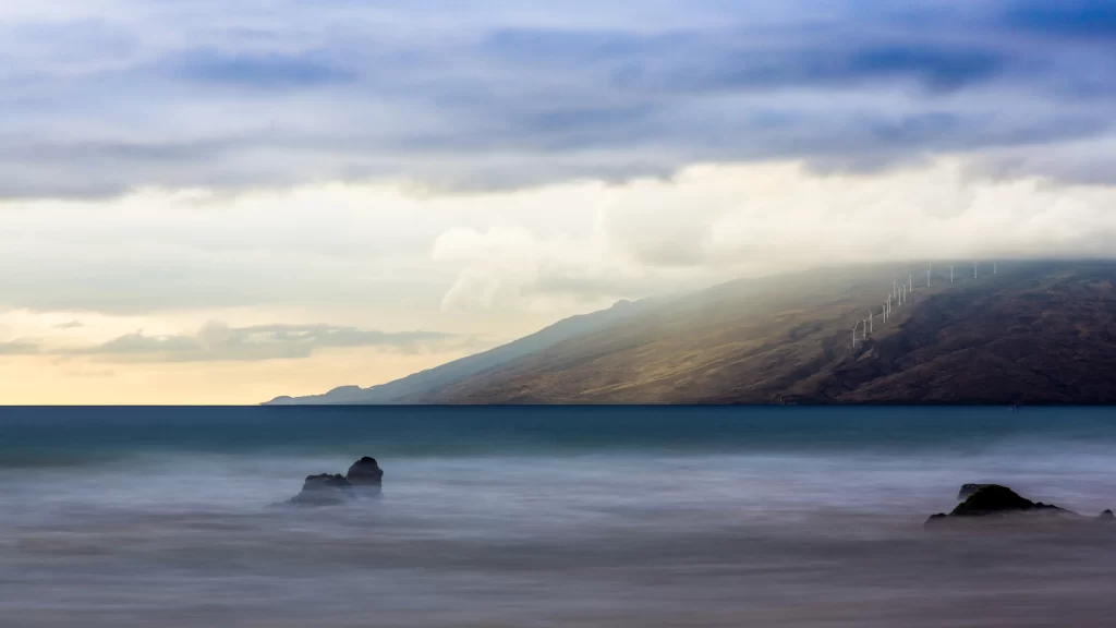 beach ocean rocks clouds sunset mountains