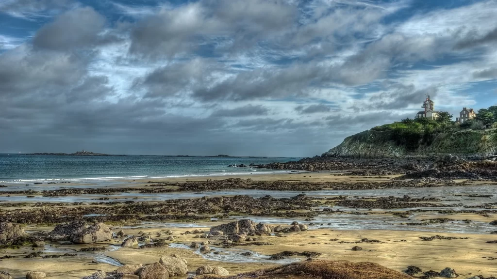beach ocean rocks sky clouds landscape