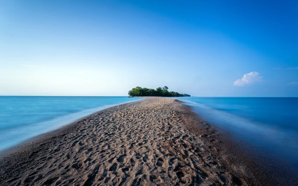 beach ocean sand island sky clouds