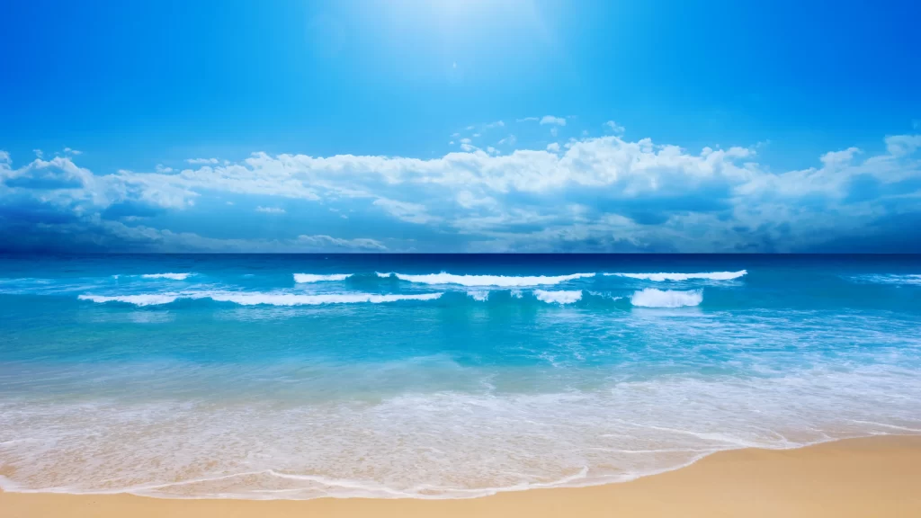 beach ocean waves sky clouds sunlight
