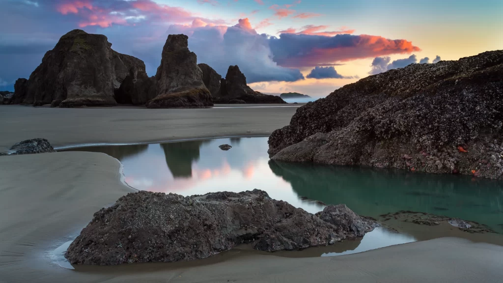 beach sunset rocks clouds water sky