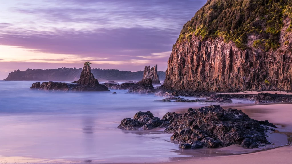 beach sunset rocks ocean cliffs sky