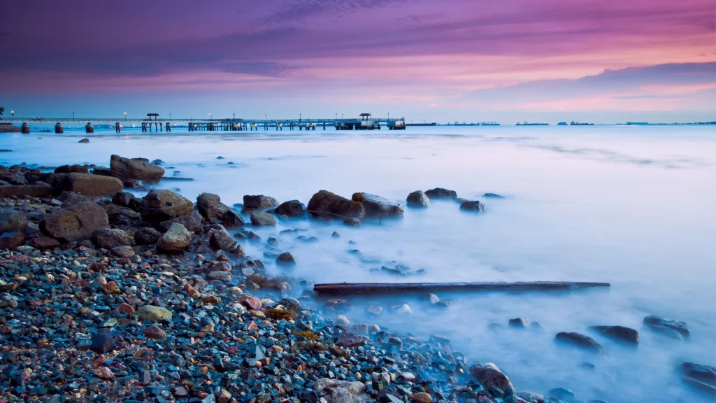 beach sunset rocks pier sky water
