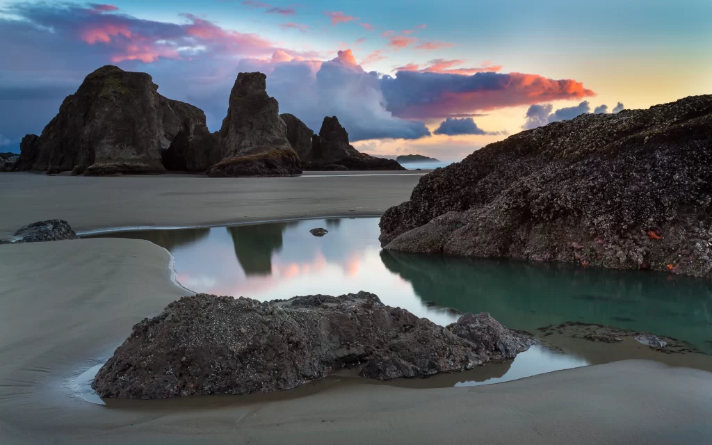 beach sunset rocks water sky