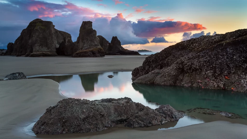 beach sunset rocks water sky