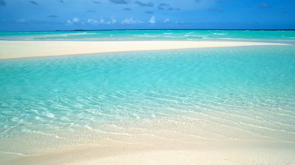 beach, turquoise water, white sand, clear sky, waves, serene