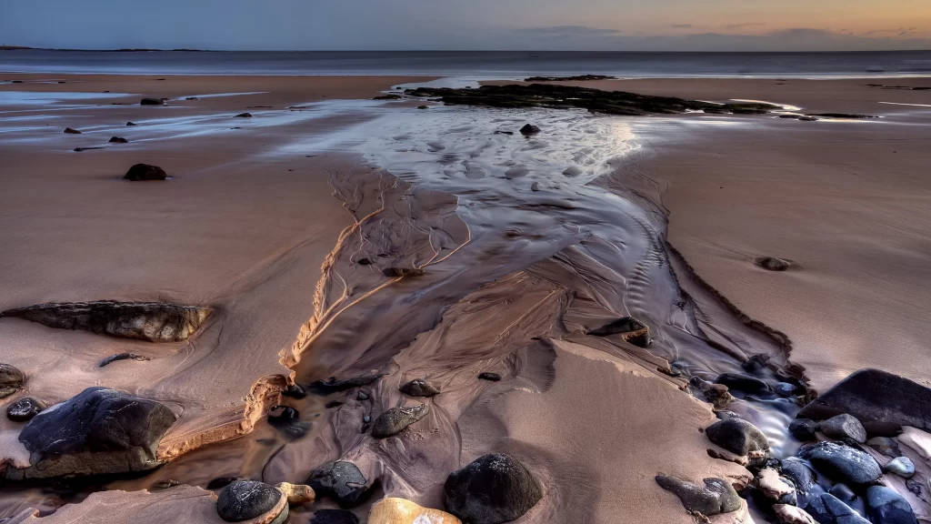 beach water rocks sunset sand waves