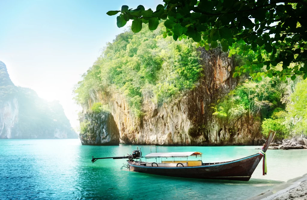 boat water beach trees mountains sunlight