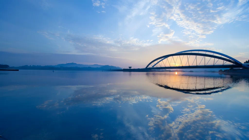 bridge sunset water reflection sky clouds